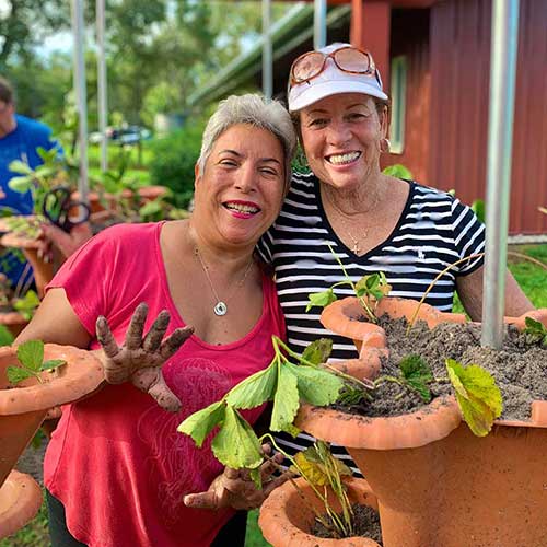 two women working on garden together