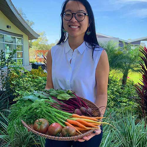 woman holding veggies from garden