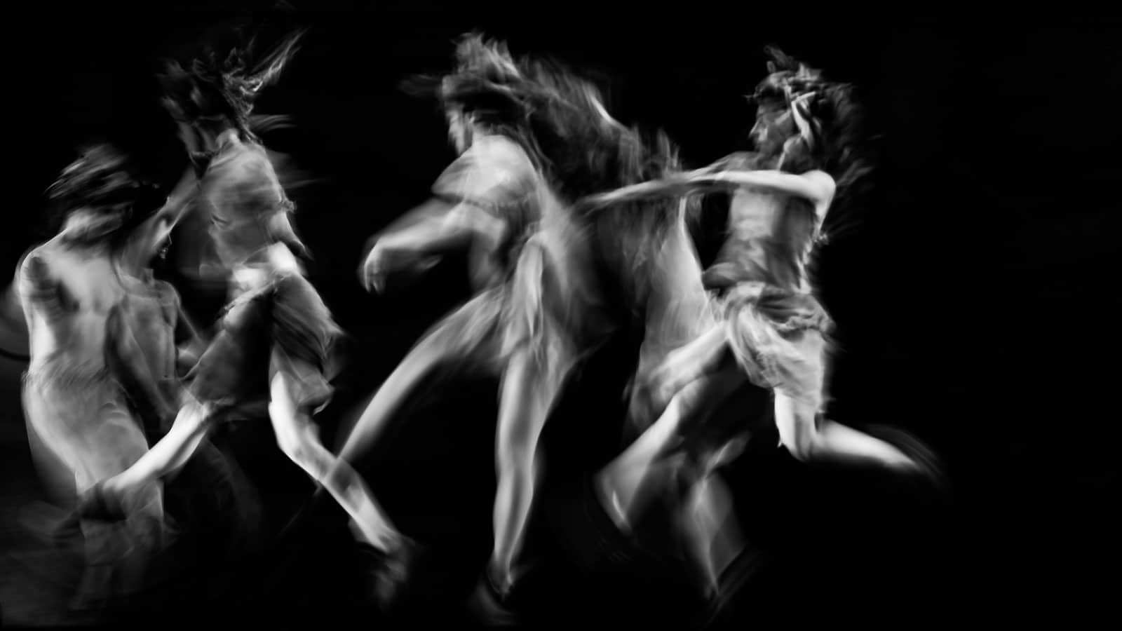 scenography of dancers dancing in black and white